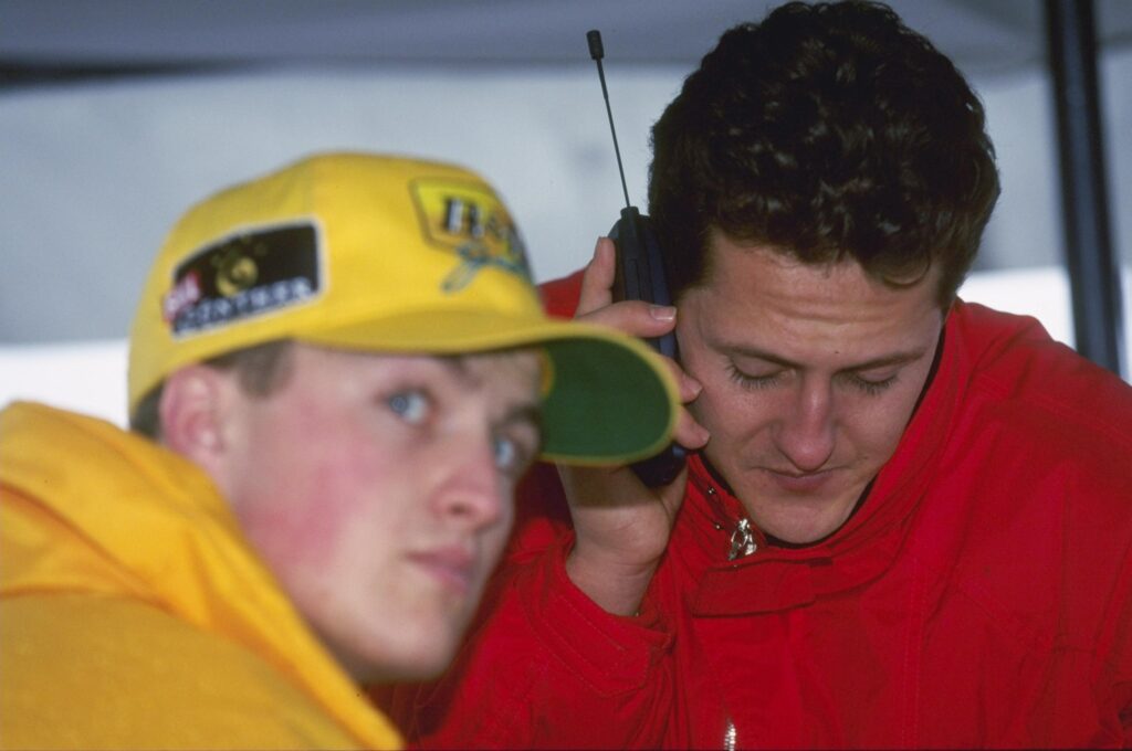 Michael Schumaer of Germany and the Ferrari team (on the phone) sits with brother Ralph