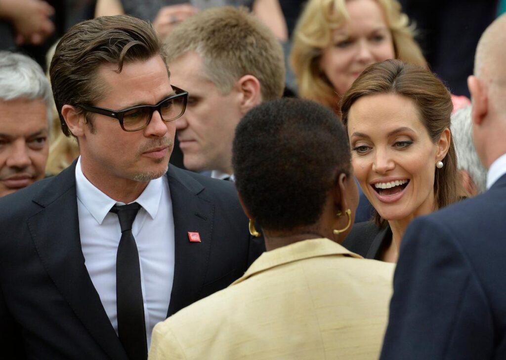 U.S. actress and campaigner Angelina Jolie (R) and Brad Pitt (C